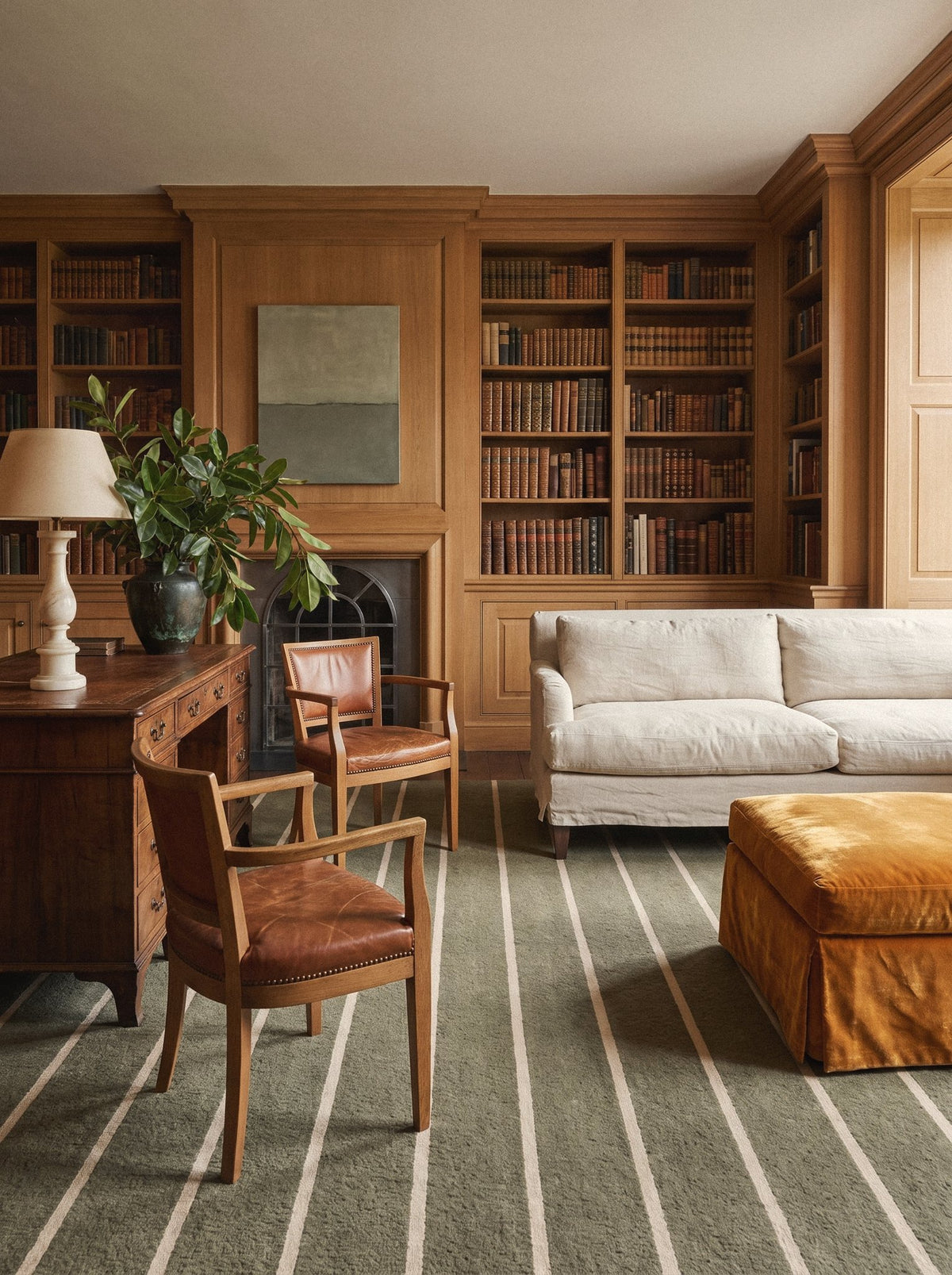 Article 221 olive pinstripe merino wool and cashmere hand-loomed rug in a paneled library