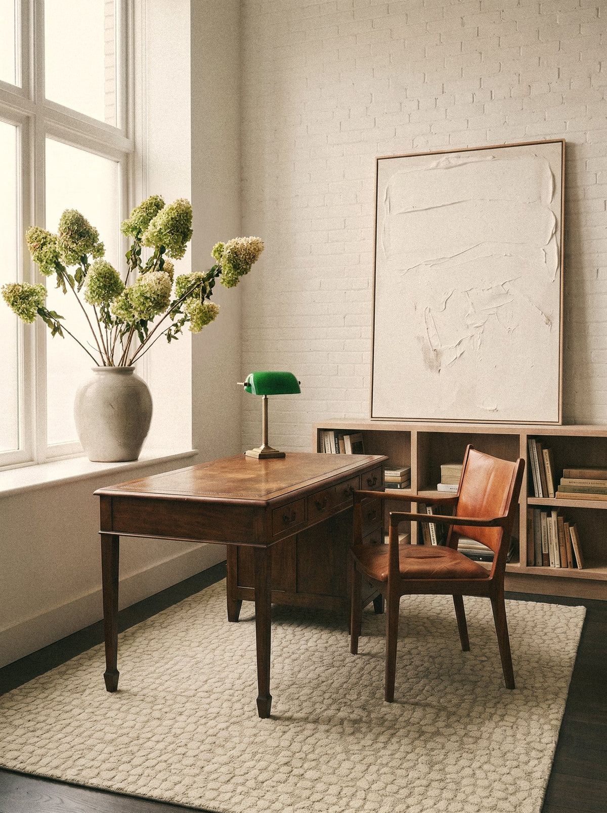 Article 442 ivory pebble alpaca hand-knotted rug in a loft with a desk