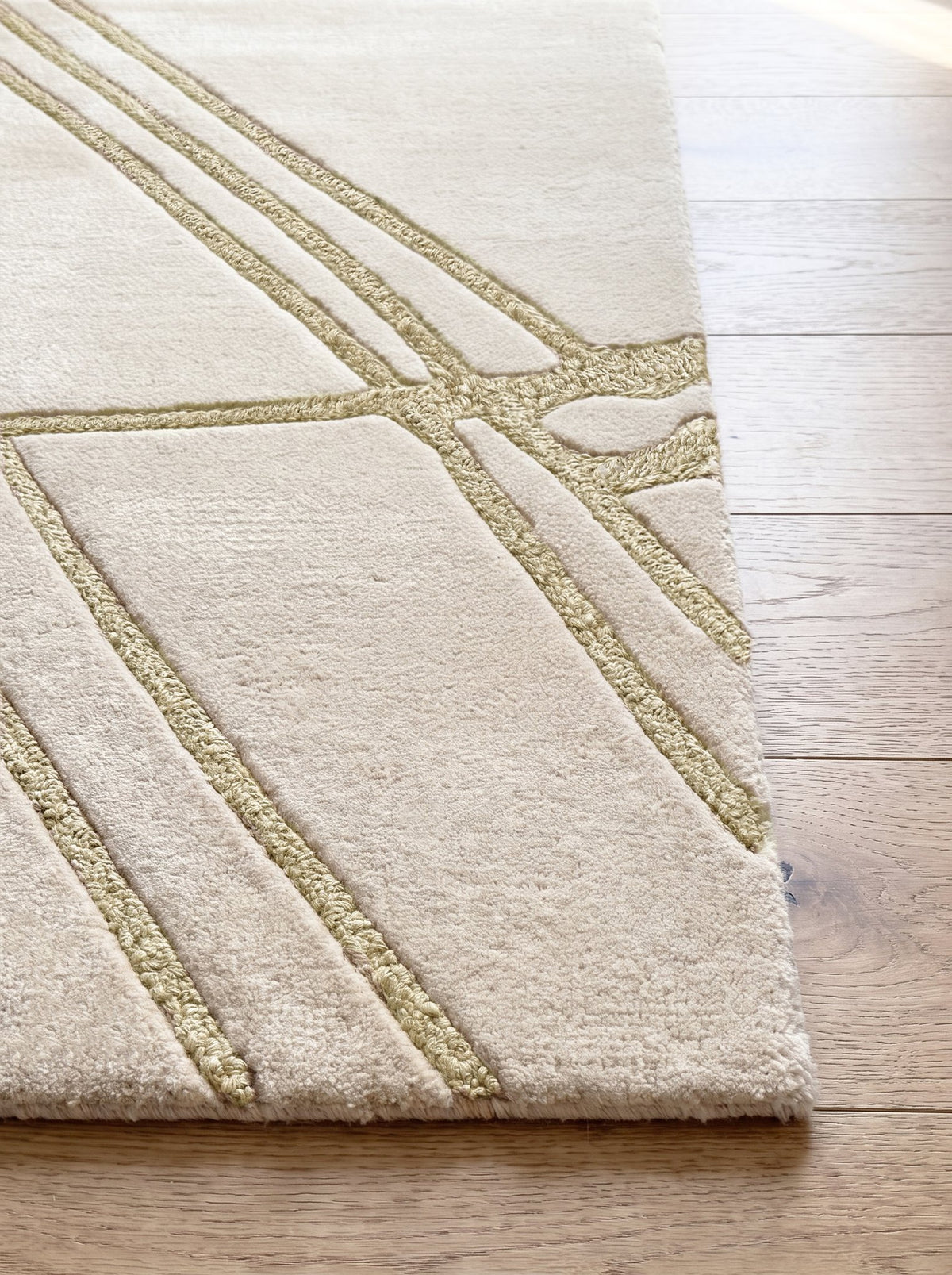 Corner of the Article 443 ivory abstract line alpaca and linen hand-knotted rug showing the pile and finished edge