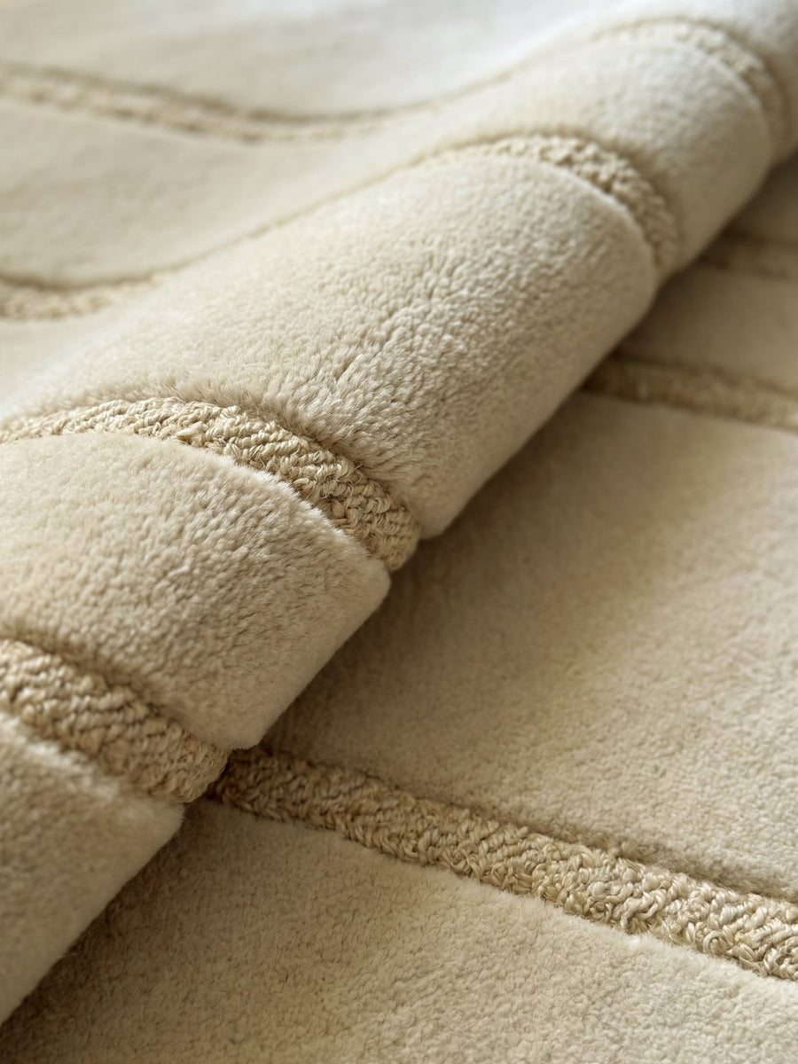 Article 443 ivory abstract line alpaca and linen hand-knotted rug folded back to show pile depth and texture