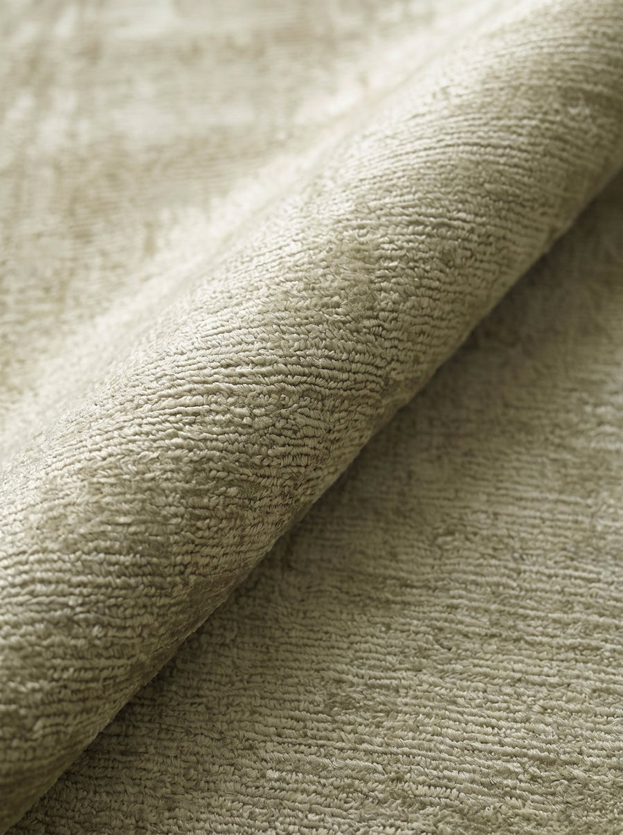 Article 522 sage distressed silk hand-loomed rug folded back to show pile depth and texture
