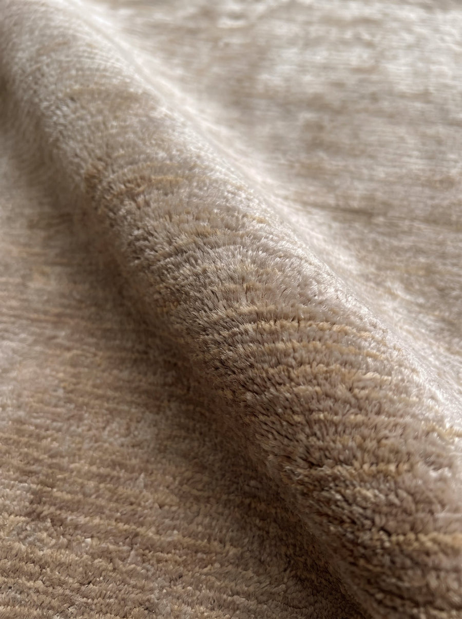 Article 541 taupe heathered silk and linen hand-knotted rug folded back to show pile depth and texture