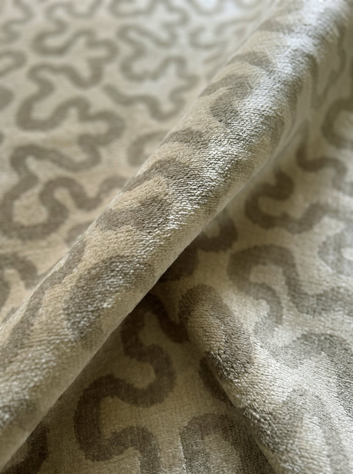 Article 641 sage squiggle cashmere and silk hand-knotted rug folded back to show pile depth and texture