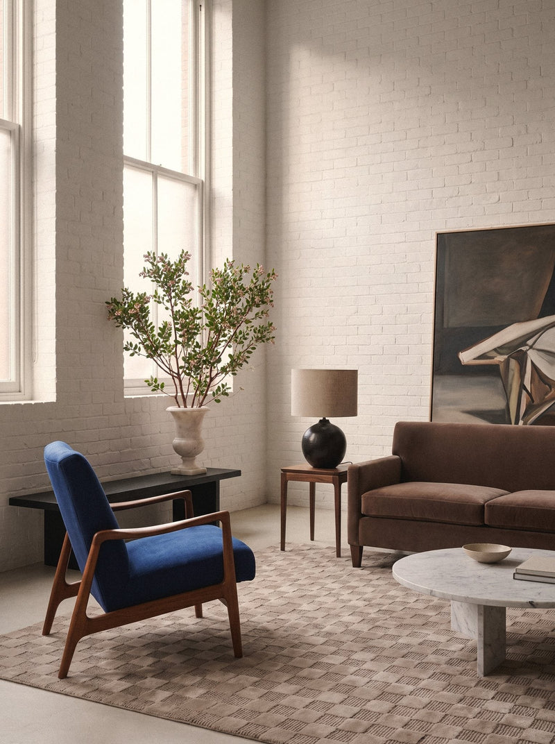 Article 241 taupe checkerboard merino wool and cashmere hand-knotted rug in a loft living room