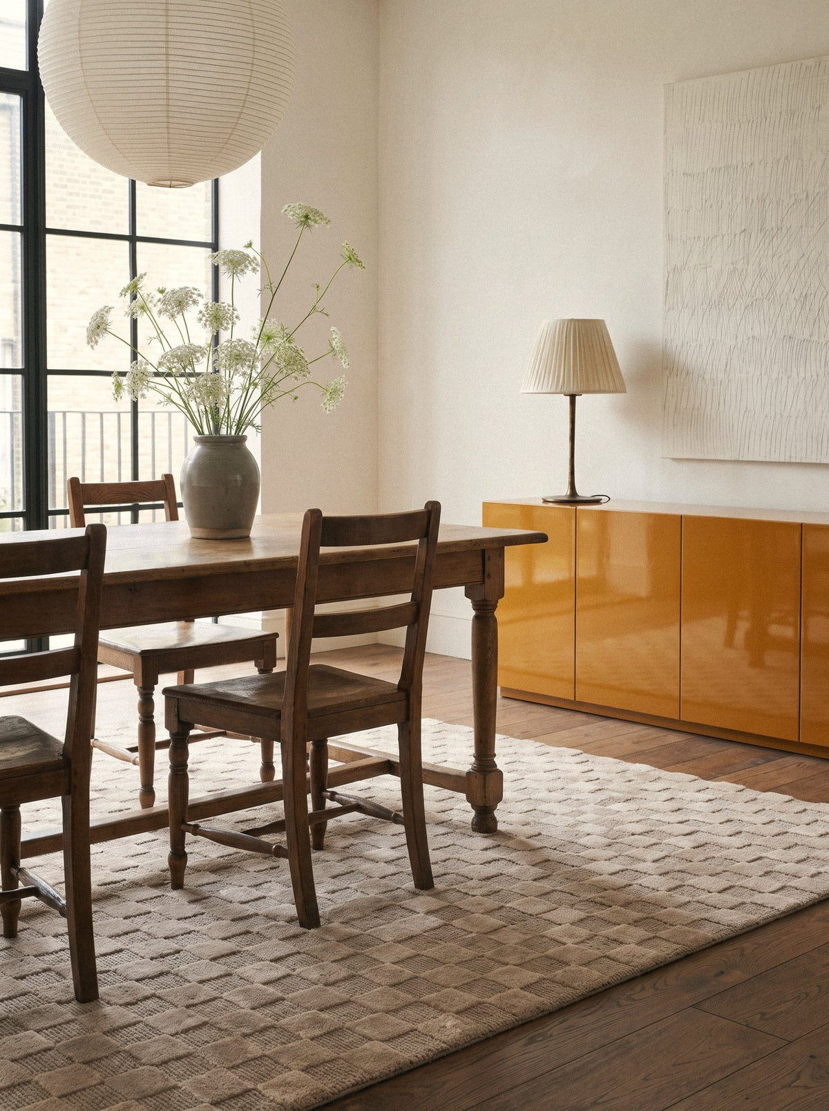 Article 241 taupe checkerboard merino wool and cashmere hand-knotted rug in a dining room