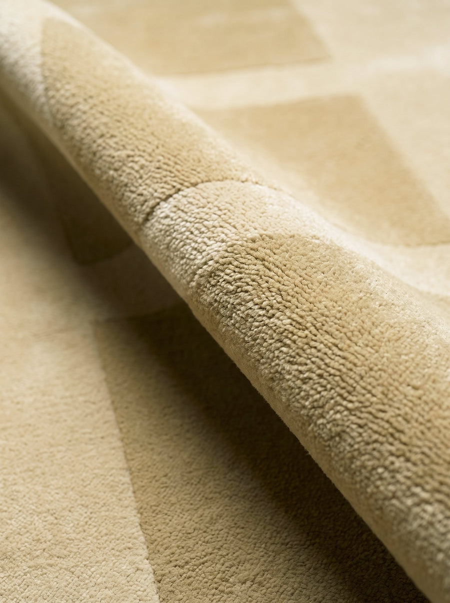Article 242 camel color block merino wool hand-knotted rug folded back to show pile depth and texture
