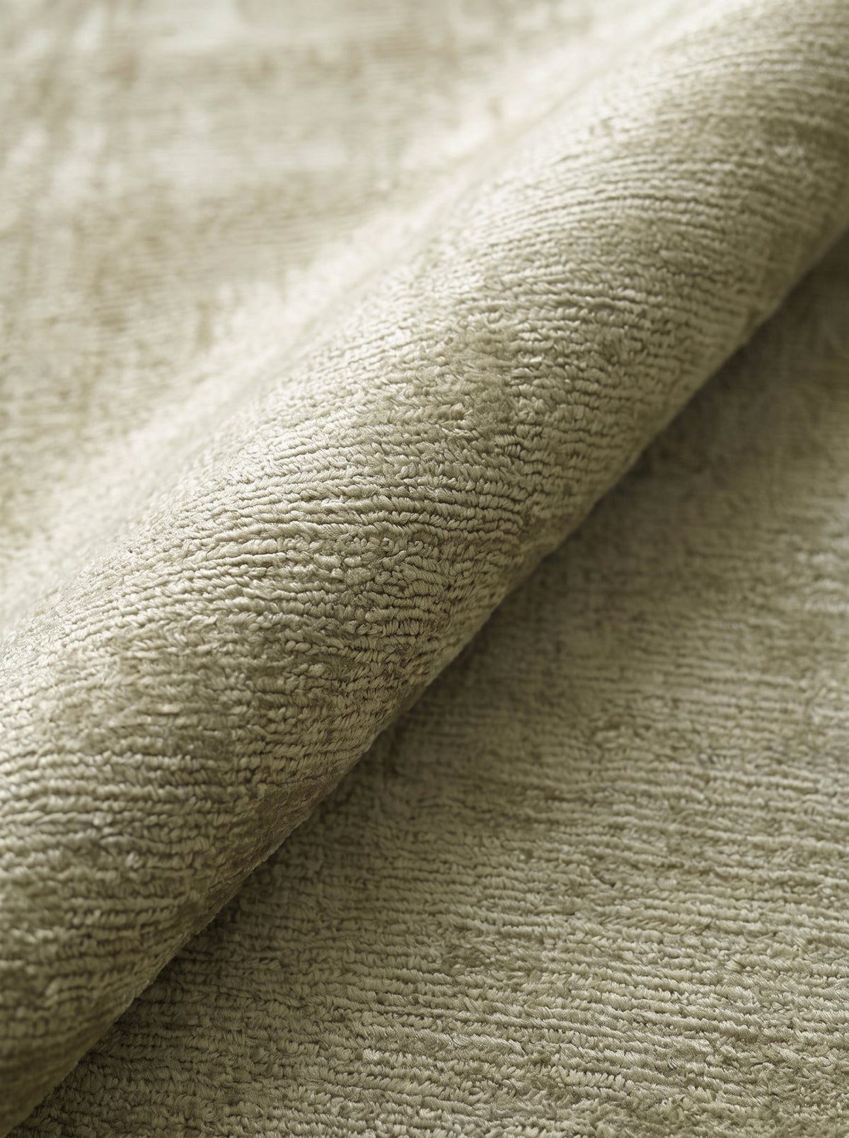Article 522 sage distressed silk hand-loomed rug folded back to show pile depth and texture